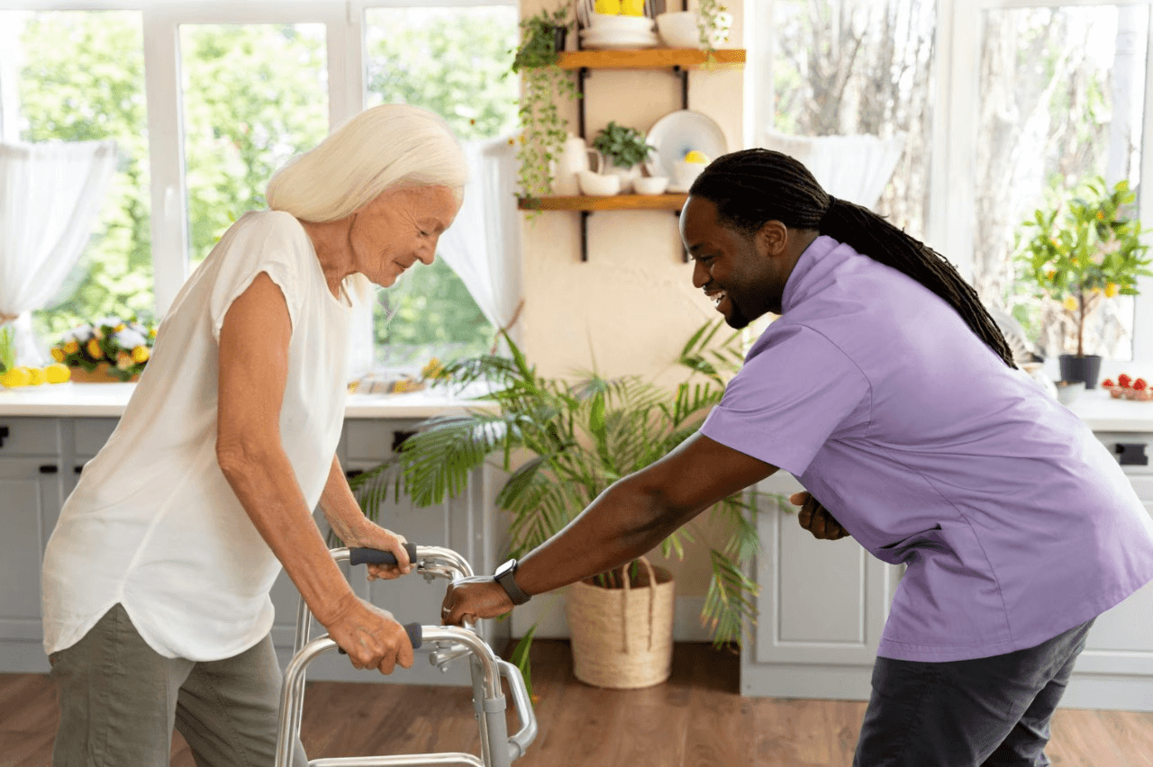 Professional caregiver helping elderly patient at home